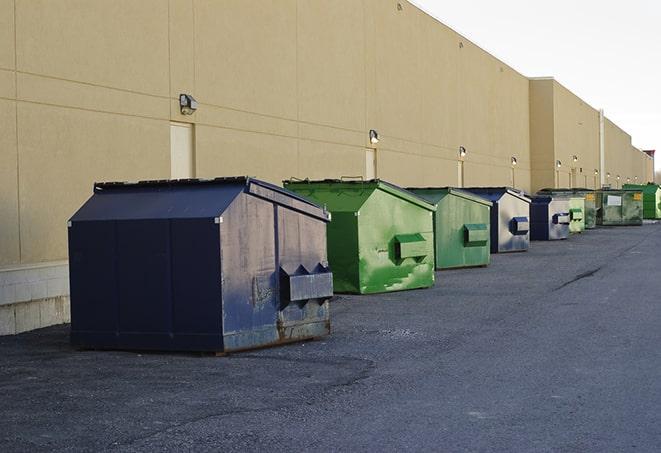 a red construction dumpster placed in front of a building under construction in Boca Grande